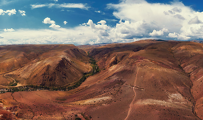 Image showing Aerial shot of the textured yellow nad red mountains resembling the surface of Mars