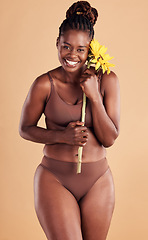 Image showing Beauty, wellness and portrait of black woman with sunflower in studio for skincare, self care and self love. Health, cosmetics and plus size girl with flower for natural beauty products and makeup