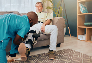 Image showing Senior man, physiotherapist and leg brace for rehabilitation, injury and support for wellness, muscle or knee. Man, sofa and physiotherapy with nurse, doctor or caregiver for health, training or talk