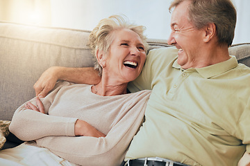 Image showing Elderly couple, laugh and hug on sofa in happy relationship, silly face or bonding together at home. Senior couple laughing, humor or relaxing while making funny goofy faces on living room couch