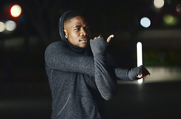 Image showing Black man, stretching arms or night fitness in city workout or training exercise in healthcare, cardiovascular wellness or body muscle growth. Runner, sports athlete or person warm up in late evening