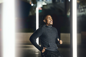 Image showing African runner man, night and city for training, speed exercise or wellness on dark street with focus. Black man running, evening workout and urban metro for fitness, balance or fast run in Cape Town