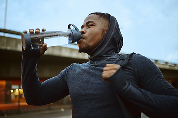 Image showing Black man, drinking water or city fitness break for sunrise workout, healthcare training or wellness morning exercise. Runner, sports athlete or drink bottle for personal trainer with running goals