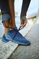 Image showing Workout, fitness and man tying shoes on feet on city street before marathon training or running. Health, wellness and sports footwear, motivation for exercise for black man athlete or urban runner.