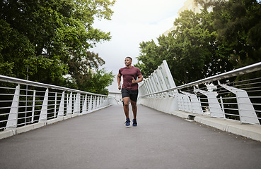 Image showing Running, bridge and black man athlete training for marathon run, wellness and sports. Speed cardio, runner workout and fitness workout of a man doing health exercise on a urban road in the morning