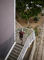 Image showing Running, fitness and training with man on stairs for sports, workout and cardio endurance. Mindset, challenge and focus with runner on steps of building for speed, exercise and sports marathon