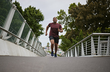 Image showing Black man running on bridge in city for fitness, exercise and healthy goals, sports wellness and marathon workout. Urban runner, cardio and training to lose weight with power, action and motivation