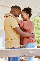 Image showing Black couple, love hug and relax in home patio, smiling and bonding. Support, affection and happy man and woman hugging, embrace or cuddle face to face, having fun and enjoying quality time together.