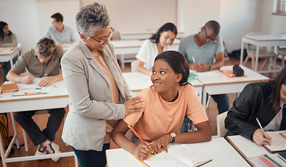 Image showing Teacher, student and classroom for test, knowledge and learning for higher education. Young female, black woman or educator helping pupil in exams, talking or students writing notes in books or focus