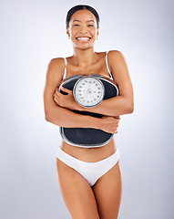 Image showing Portrait, black woman and scale for diet, weight loss and smile for healthy lifestyle, wellness and relax on grey studio background. African American female, weigh and health for body care or balance