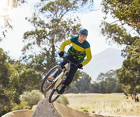 Image showing Mountain bike man, air ramp and outdoor with helmet, extreme sport and focus for fitness, speed and training. Bmx bicycle. sports expert and fast jump in nature, trail and cycling for competition