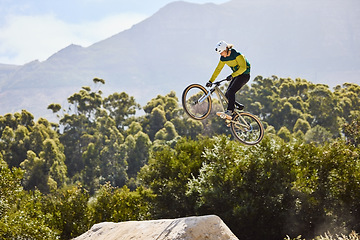 Image showing Mountain biking, sports and man training in nature, cycling energy and in air for a competition in Turkey. Exercise, danger and athlete with a mountain bike for fitness, speed and jump during contest