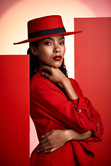 Image showing Fashion, studio and stylish woman in a suit with a seductive, sensual and elegant outfit. Edgy, fashionable and portrait of female African model with trendy style posing by orange and red background.