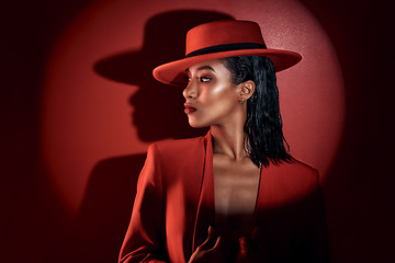 Image showing Fashion, spotlight and woman in red suit, vintage clothing or retro outfit. Thinking, aesthetic and stylish, confident and classy female model in 90s designer hat isolated on a dark studio background