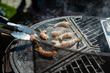 Image showing A professional cook prepares shrimps