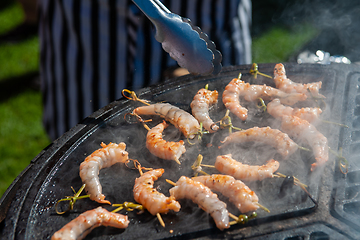 Image showing A professional cook prepares shrimps