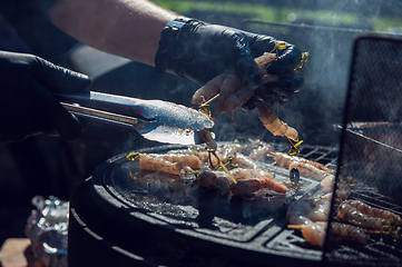 Image showing A professional cook prepares shrimps