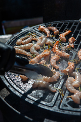 Image showing A professional cook prepares shrimps