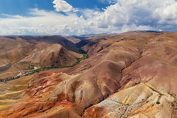 Image showing Aerial shot of the textured yellow nad red mountains resembling the surface of Mars