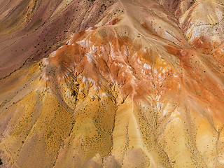 Image showing Aerial shot of the textured yellow nad red mountains resembling the surface of Mars