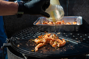 Image showing A professional cook prepares shrimps