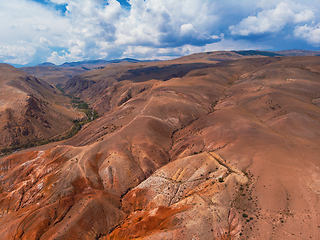 Image showing Aerial shot of the textured yellow nad red mountains resembling the surface of Mars