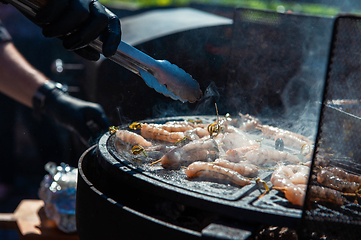 Image showing A professional cook prepares shrimps