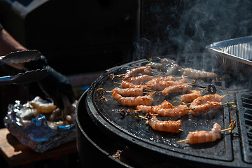 Image showing A professional cook prepares shrimps