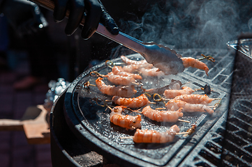 Image showing A professional cook prepares shrimps