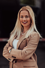 Image showing A powerful portrait of a businesswoman, standing confidently with her arms crossed, representing the determination of the female gender and embodying strength and success