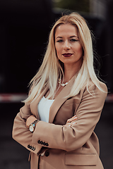 Image showing A powerful portrait of a businesswoman, standing confidently with her arms crossed, representing the determination of the female gender and embodying strength and success