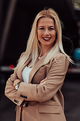 Image showing A powerful portrait of a businesswoman, standing confidently with her arms crossed, representing the determination of the female gender and embodying strength and success