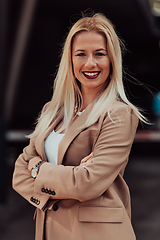 Image showing A powerful portrait of a businesswoman, standing confidently with her arms crossed, representing the determination of the female gender and embodying strength and success