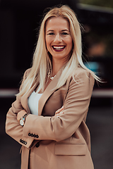 Image showing A powerful portrait of a businesswoman, standing confidently with her arms crossed, representing the determination of the female gender and embodying strength and success