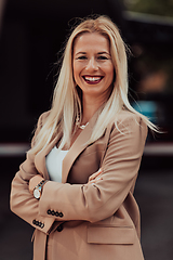 Image showing A powerful portrait of a businesswoman, standing confidently with her arms crossed, representing the determination of the female gender and embodying strength and success