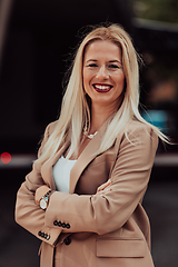 Image showing A powerful portrait of a businesswoman, standing confidently with her arms crossed, representing the determination of the female gender and embodying strength and success