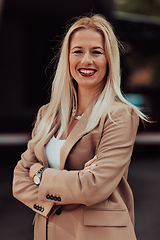 Image showing A powerful portrait of a businesswoman, standing confidently with her arms crossed, representing the determination of the female gender and embodying strength and success