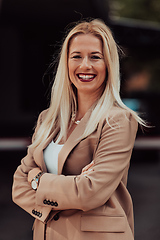 Image showing A powerful portrait of a businesswoman, standing confidently with her arms crossed, representing the determination of the female gender and embodying strength and success