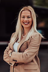 Image showing A powerful portrait of a businesswoman, standing confidently with her arms crossed, representing the determination of the female gender and embodying strength and success