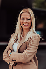 Image showing A powerful portrait of a businesswoman, standing confidently with her arms crossed, representing the determination of the female gender and embodying strength and success