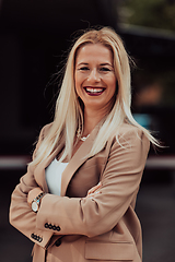 Image showing A powerful portrait of a businesswoman, standing confidently with her arms crossed, representing the determination of the female gender and embodying strength and success