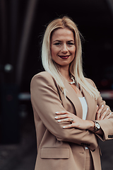 Image showing A powerful portrait of a businesswoman, standing confidently with her arms crossed, representing the determination of the female gender and embodying strength and success