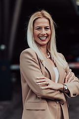 Image showing A powerful portrait of a businesswoman, standing confidently with her arms crossed, representing the determination of the female gender and embodying strength and success