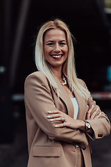 Image showing A powerful portrait of a businesswoman, standing confidently with her arms crossed, representing the determination of the female gender and embodying strength and success