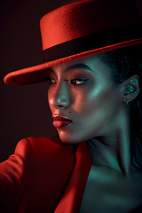 Image showing Fashion, dark and stylish woman in a studio with a seductive, vintage and elegant outfit. Sensual, fashionable and mysterious African female in a red suit posing while isolated by a black background.
