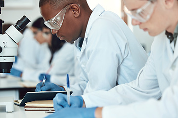 Image showing Science students, research and writing in laboratory, experiment and healthcare innovation. Researchers, notebooks and make notes for medical scientific methods, exams and analysis for cure and focus