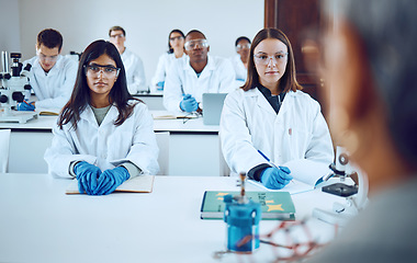 Image showing University, education and science students with professor in classroom. College books, learning and group of people, men and women in lab coats with teacher, lecturer or educator studying biology.