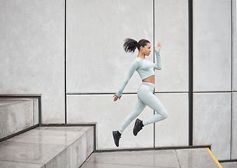 Image showing Running stairs and jump of a black woman doing training, sport and exercise with energy. Jumping, runner and morning fitness of woman doing sports, workout and cardio by steps for health and wellness