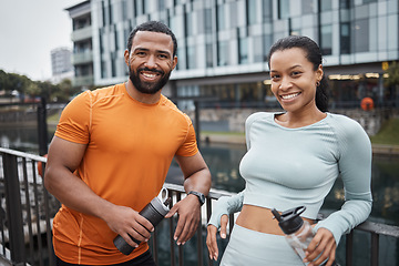 Image showing Black couple, portrait and fitness in urban city, workout partner with water bottle for hydration and relax after exercise. Happy black man with black woman and wellness, active lifestyle in Chicago.