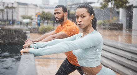 Image showing Portrait, couple in the rain or stretching for workout, fitness or wellness. Wet, man or woman training, practice routine or motivation for health, commitment or sports for energy, cardio or exercise